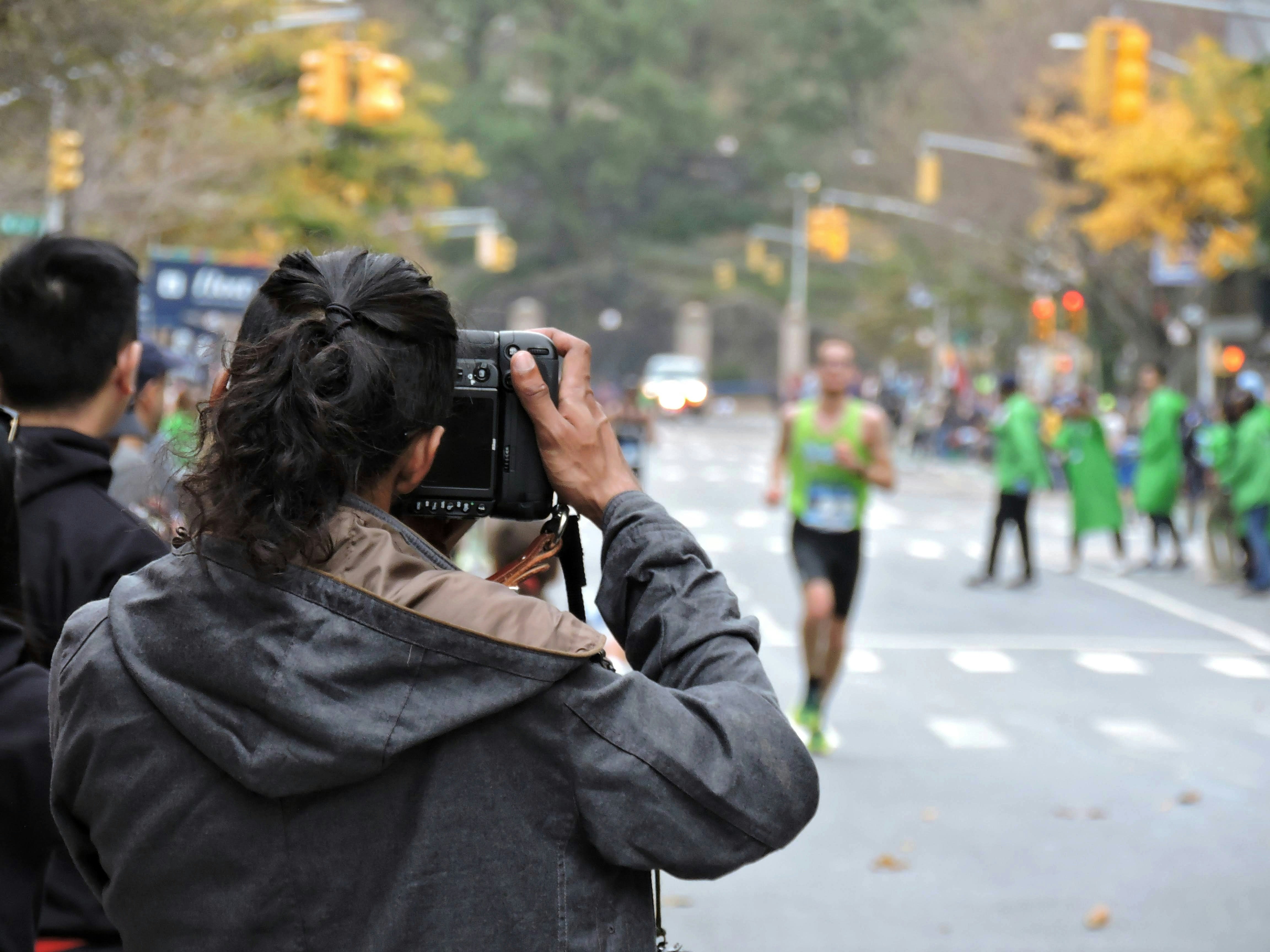 Photographer capturing runners at race event